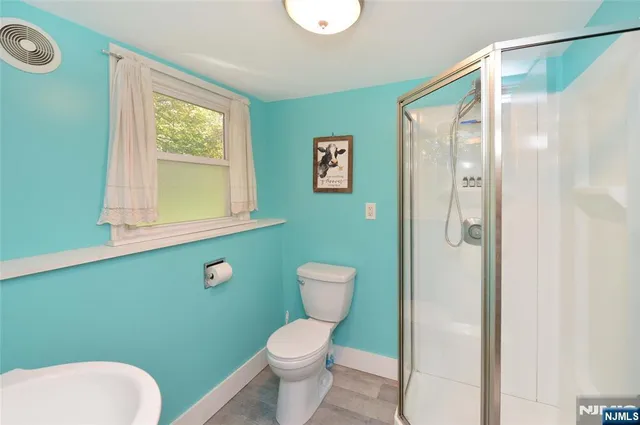 a bathroom with a toilet a sink and a mirror