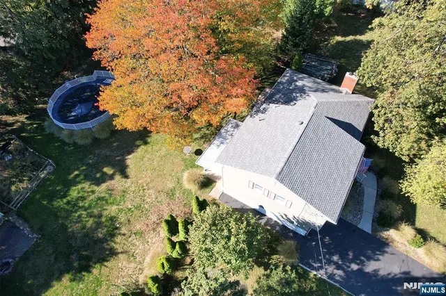 an aerial view of a house with a yard and garden