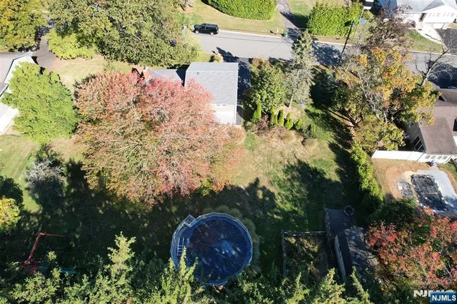 an aerial view of a house with a yard and garden