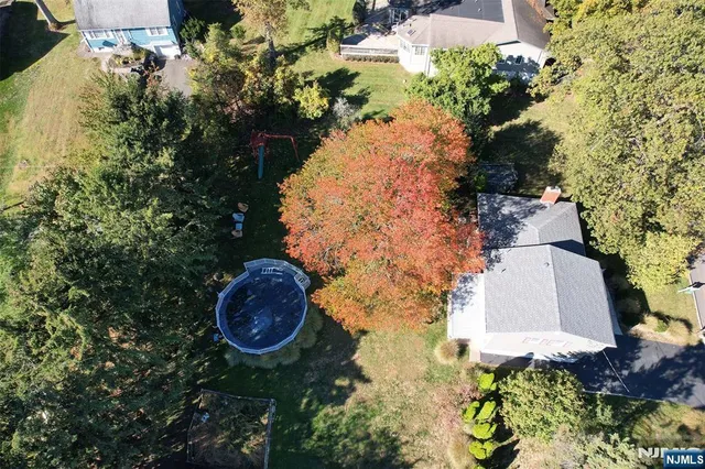 an aerial view of a house with yard swimming pool and outdoor seating