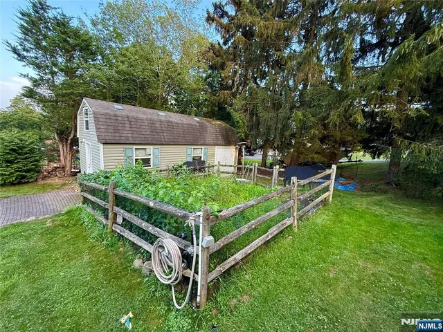 a view of backyard with deck and outdoor seating