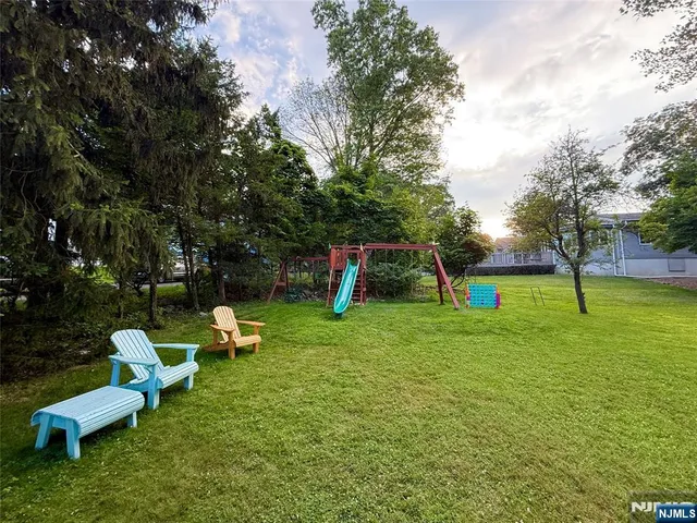 a view of a backyard with swings