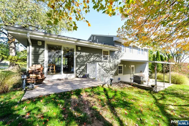 a view of a backyard with a patio and a garden