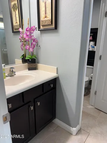 a bathroom with a sink vanity and mirror