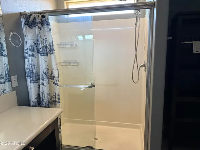 a bathroom with a shower and a sink