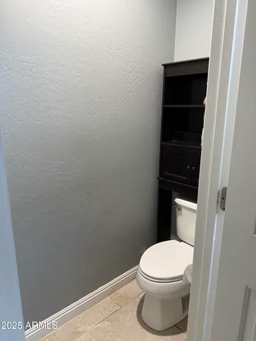 a white toilet sitting in a bathroom
