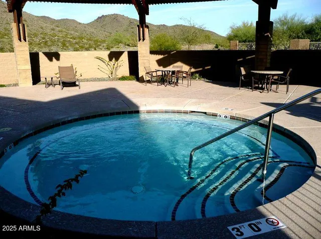 a view of a balcony with chair and wooden floor