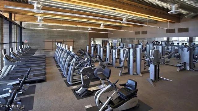 a room with gym equipment and large mirror