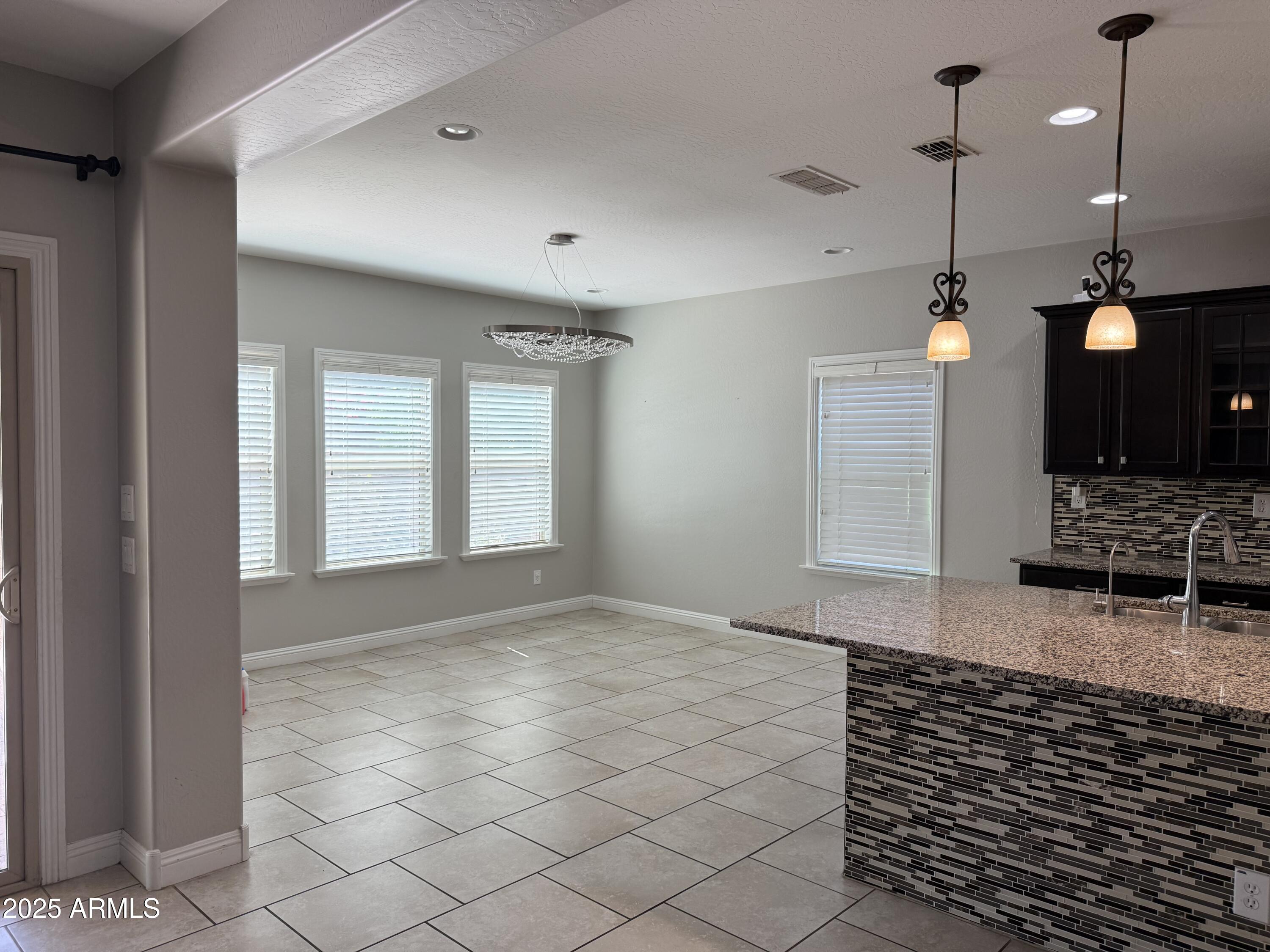 1843 West Fetlock Trail Phoenix, AZ 85085 - Photo 4 of 36 a view of an empty room with wooden floor and a window