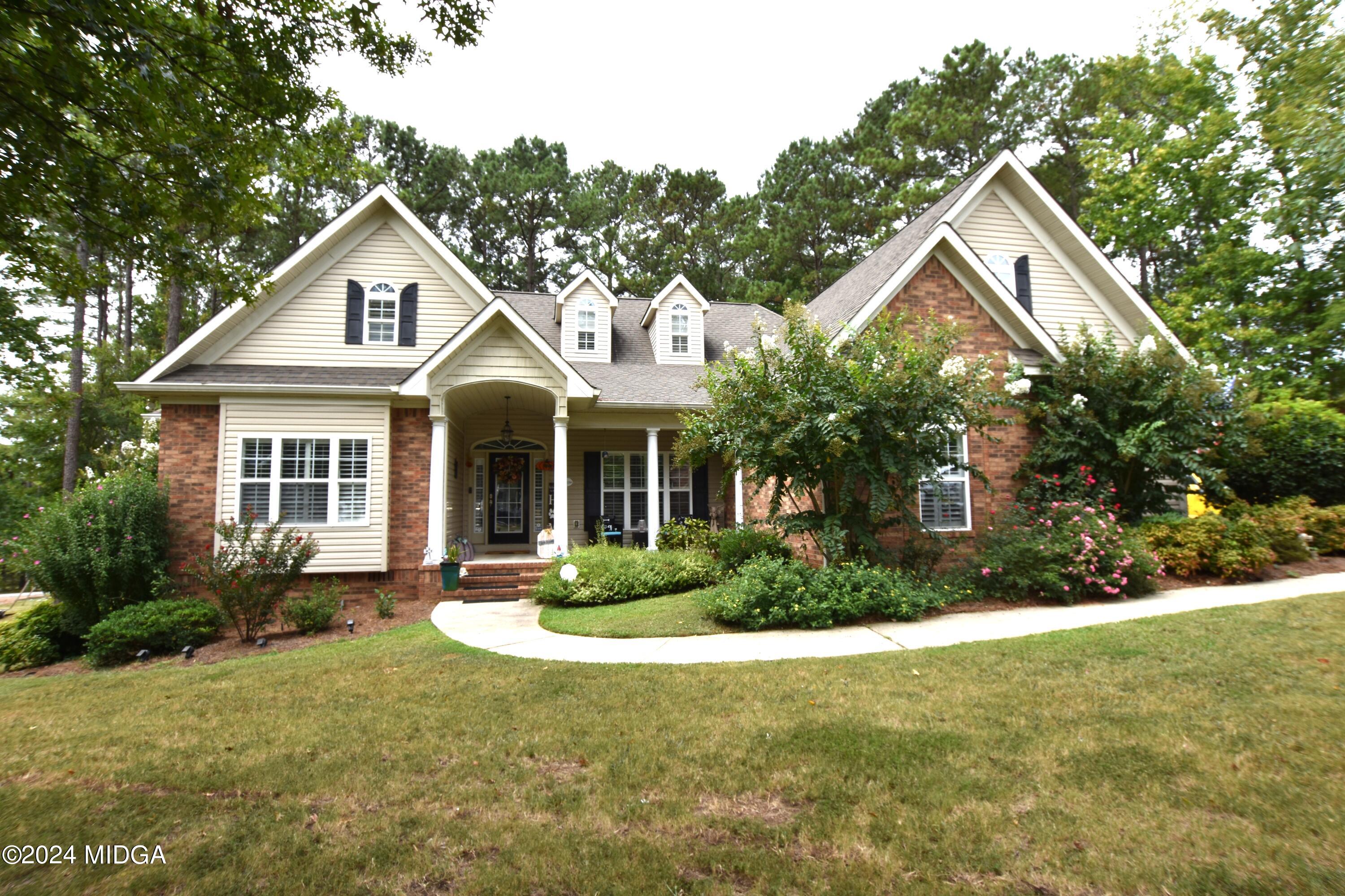 101 Lovetts Ridge Drive Juliette, GA 31046 - Photo 2 of 2 a front view of a house with a yard and garage