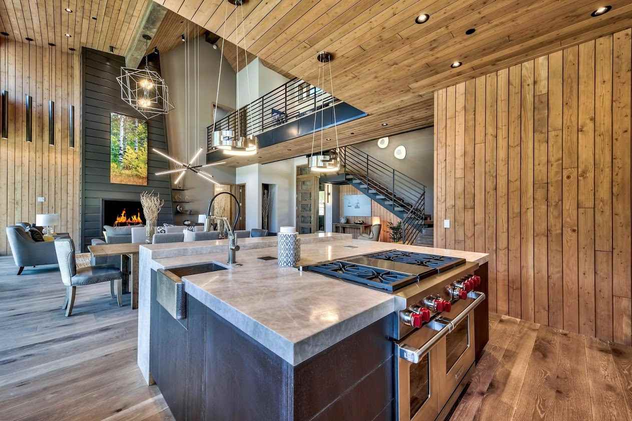 a open kitchen with stainless steel appliances granite countertop a stove and a wooden floors