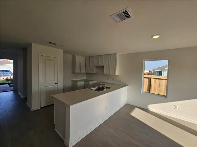 a kitchen with a stove and a refrigerator