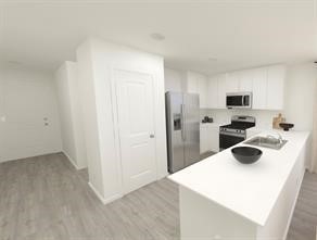 404 Nicholas Road Wharton, TX 77488 - Photo 5 of 19 a kitchen with a refrigerator a stove and a sink