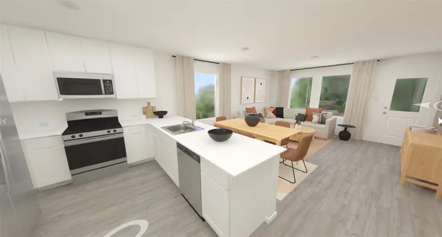 a large white open kitchen with stainless steel appliances kitchen island a stove a sink dishwasher and a refrigerator with wooden floor