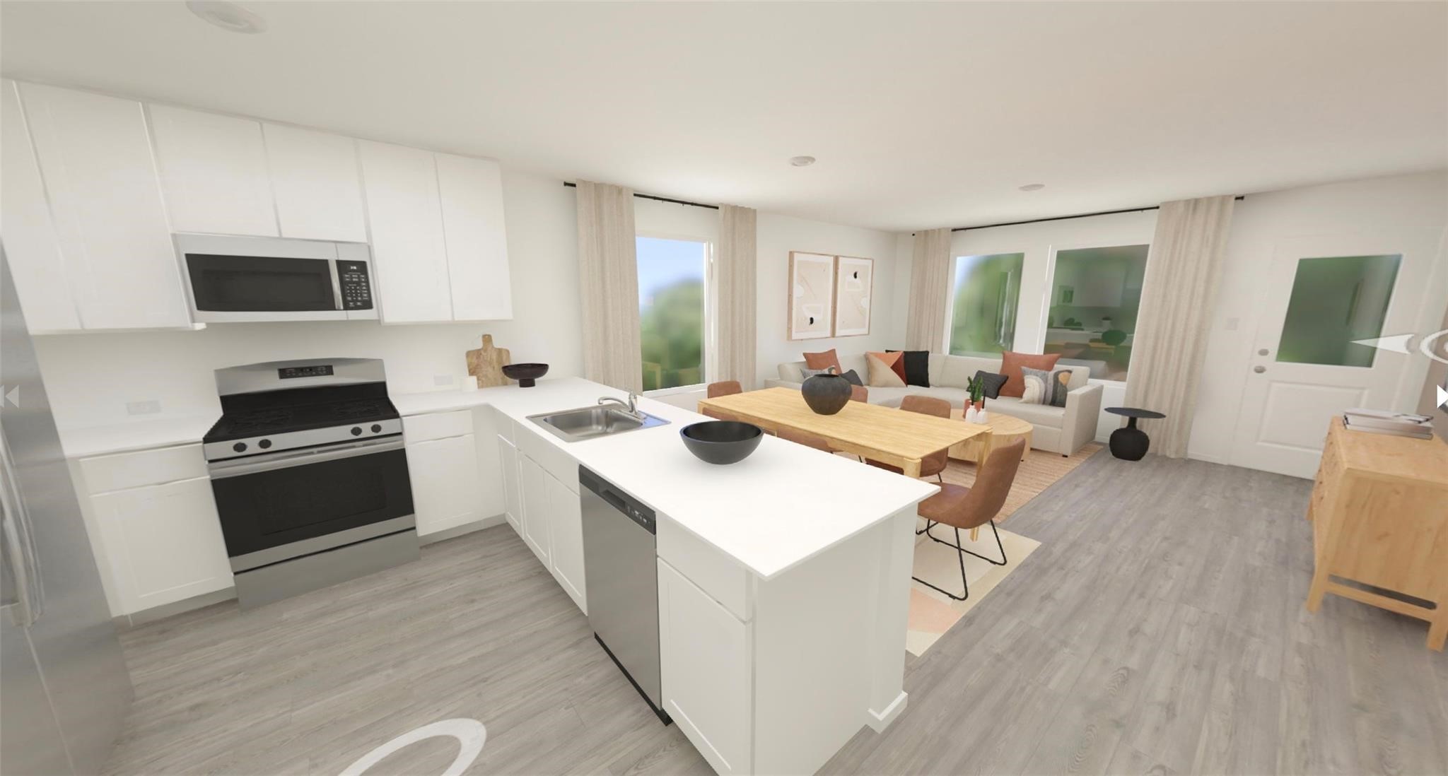 404 Nicholas Road Wharton, TX 77488 - Photo 6 of 19 a large white open kitchen with stainless steel appliances kitchen island a stove a sink dishwasher and a refrigerator with wooden floor