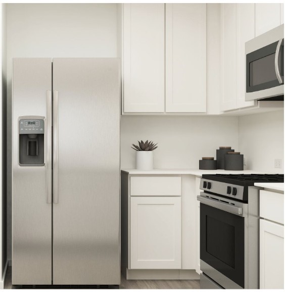 404 Nicholas Road Wharton, TX 77488 - Photo 7 of 19 a kitchen with stainless steel appliances white cabinets and a stove