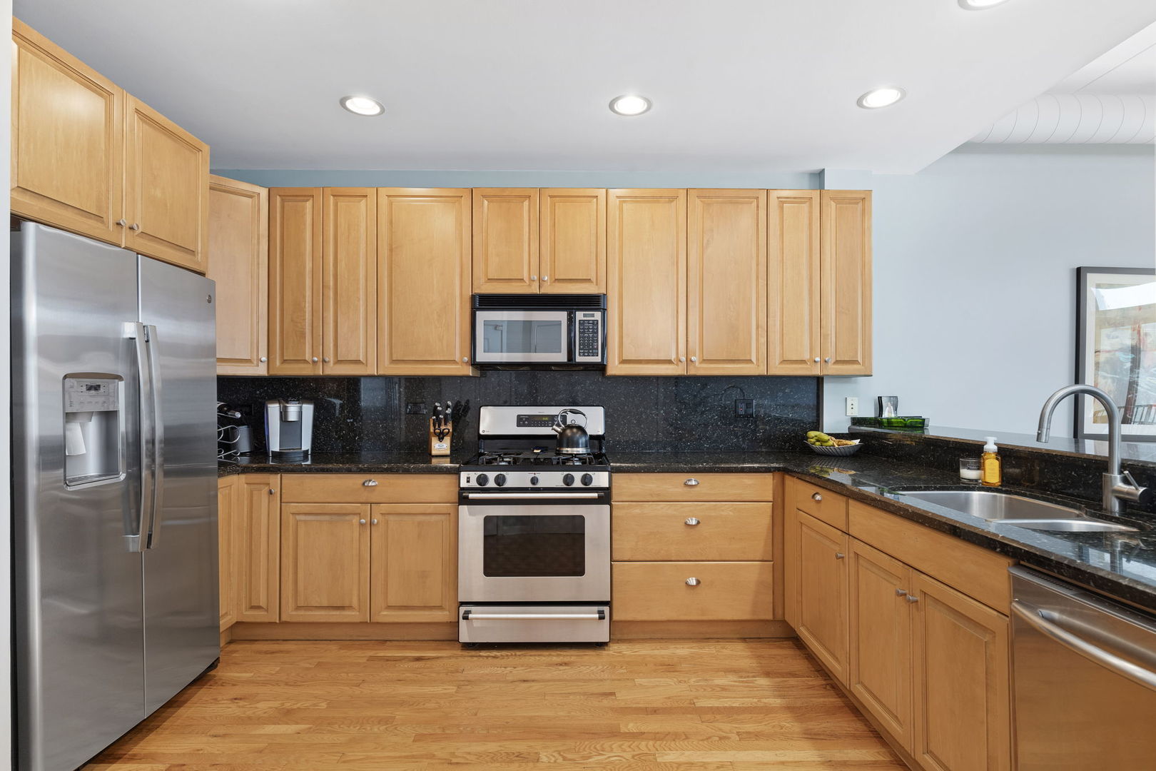 841 West Monroe Street, Unit 4B Chicago, IL 60607 - Photo 3 of 25 a kitchen with stainless steel appliances granite countertop a stove a sink and a refrigerator