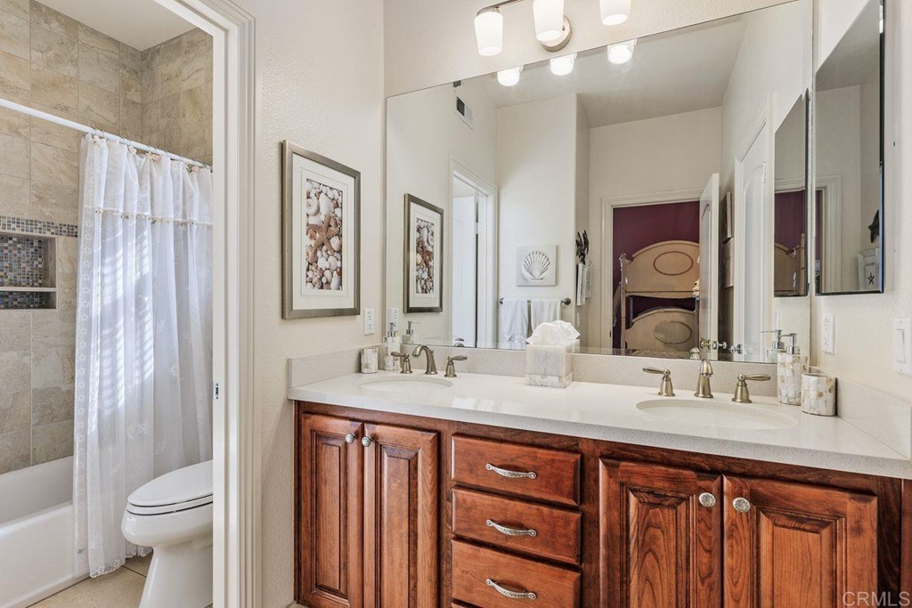 7915 Corte Penca Carlsbad, CA 92009 - Photo 37 of 50 a bathroom with a double vanity sink mirror and toilet