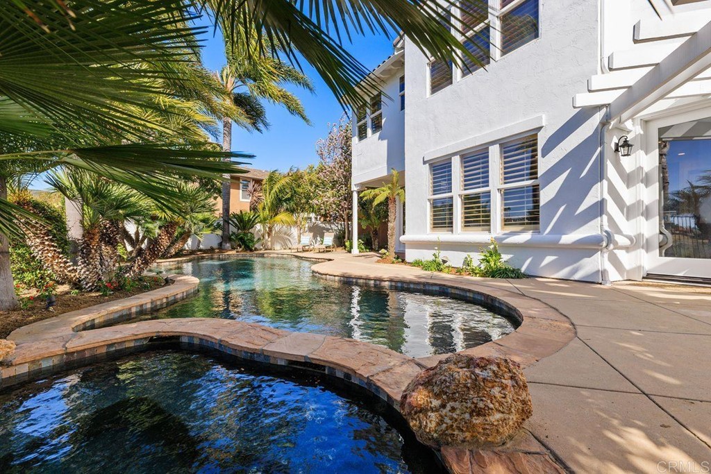 7915 Corte Penca Carlsbad, CA 92009 - Photo 50 of 50 a house with swimming pool in front of it