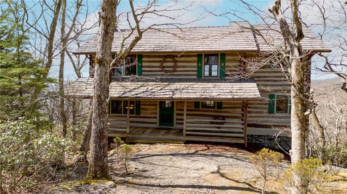 1992 Homestead Road Todd, NC 28684 - Photo 1 of 44 a view of a house with a door and a tree