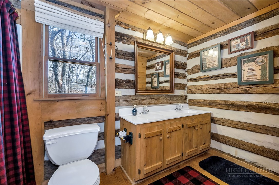 1992 Homestead Road Todd, NC 28684 - Photo 25 of 44 a bathroom with a toilet a sink and a window