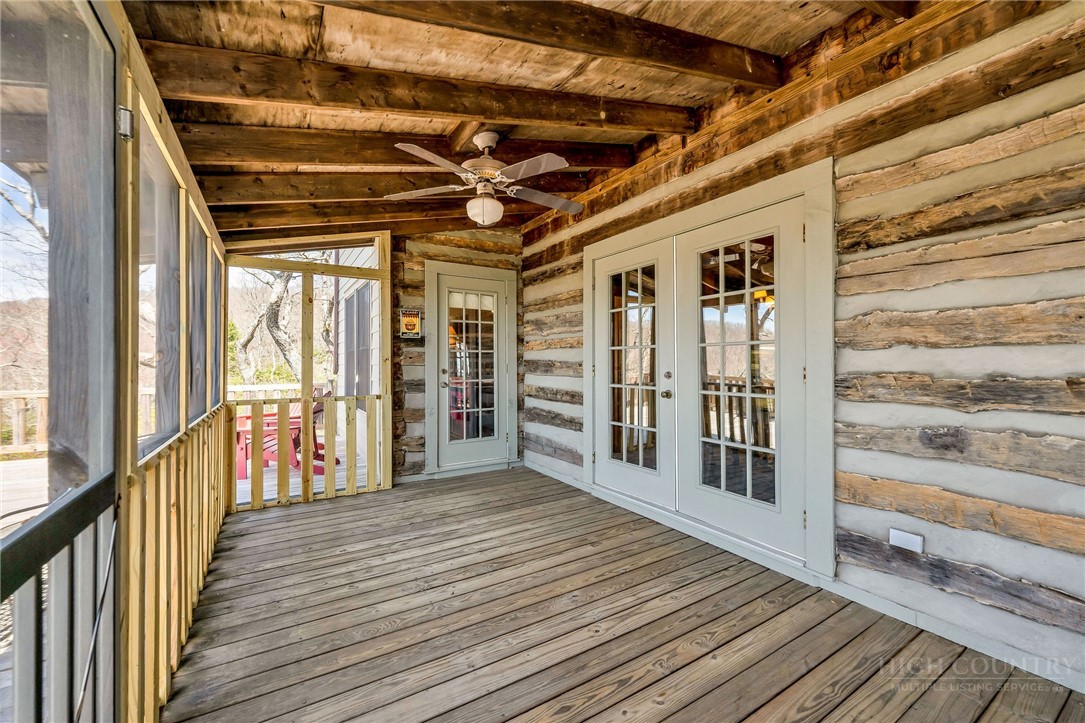 1992 Homestead Road Todd, NC 28684 - Photo 28 of 44 a view of a porch with wooden floor and iron stairs