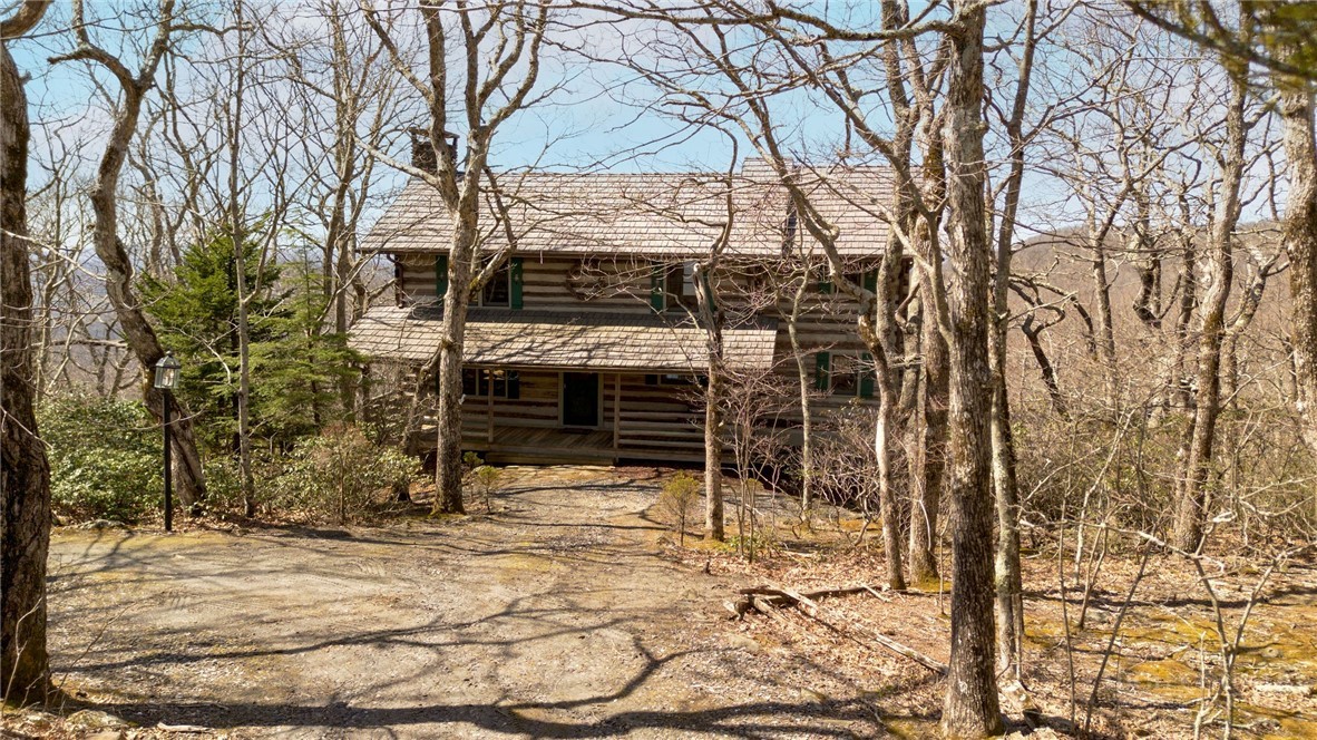1992 Homestead Road Todd, NC 28684 - Photo 3 of 44 a backyard of a house with a large tree and wooden fence