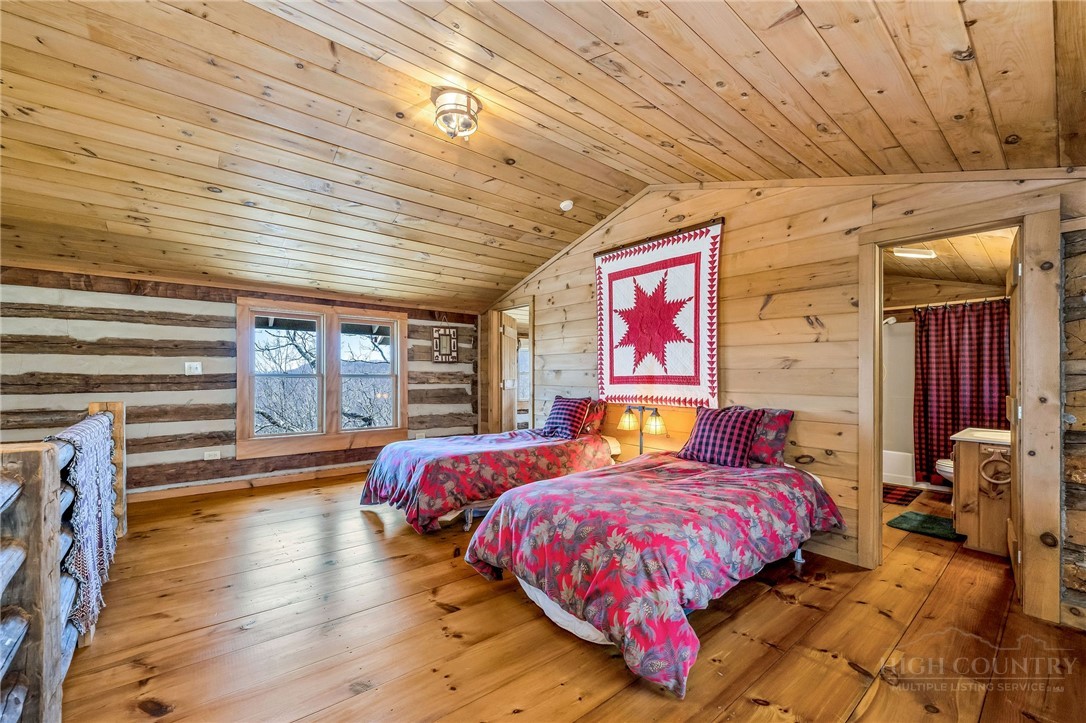 1992 Homestead Road Todd, NC 28684 - Photo 33 of 44 a spacious bedroom with a bed and wooden floor