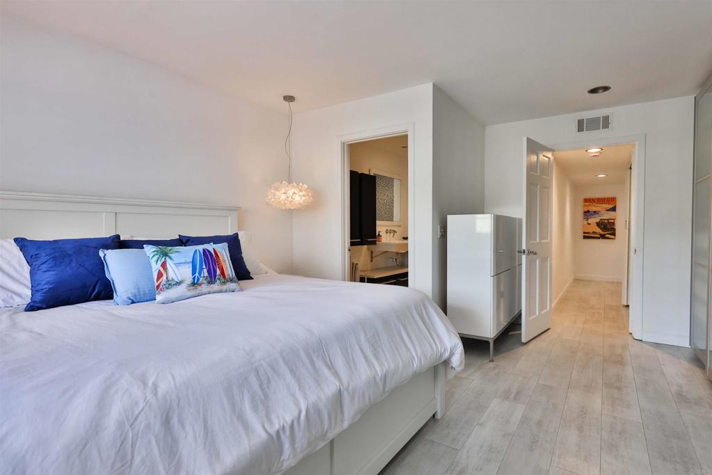 942 D Avenue, Unit B Coronado, CA 92118 - Photo 15 of 38 a bedroom with a large bed and a chandelier