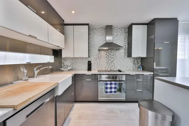 a kitchen with stainless steel appliances granite countertop a sink stove and cabinets