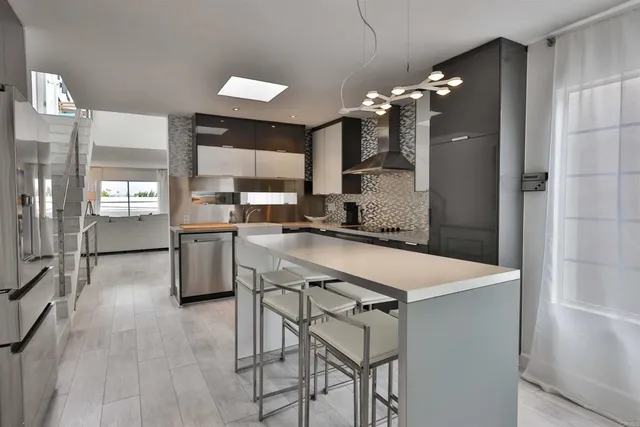 a kitchen with a table chairs refrigerator and microwave