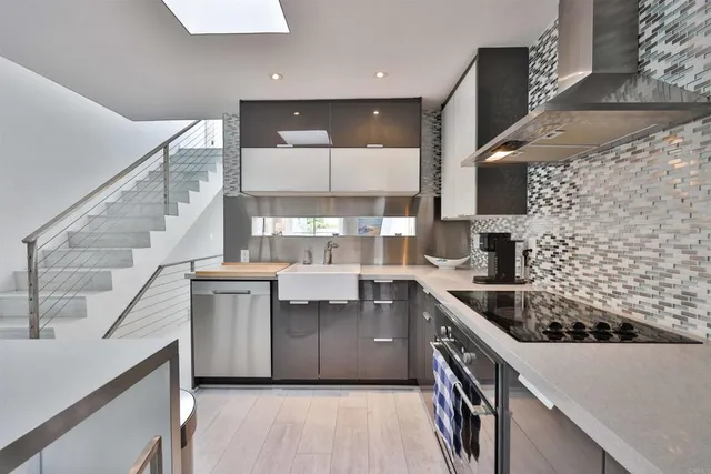 a kitchen with stainless steel appliances a sink stove and cabinets