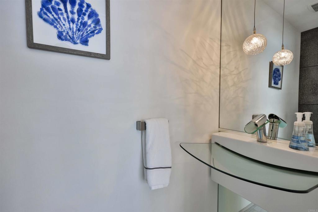 942 D Avenue, Unit B Coronado, CA 92118 - Photo 27 of 38 a bathroom with a sink and a mirror