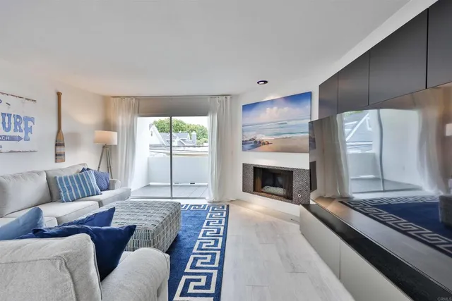 a living room with furniture fireplace and window