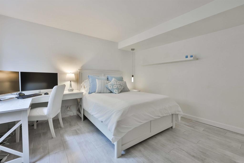 942 D Avenue, Unit B Coronado, CA 92118 - Photo 8 of 38 a bedroom with a bed and a flat screen tv