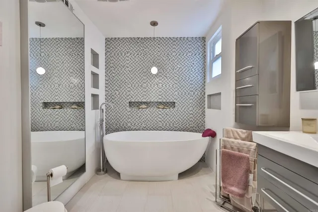 a bathroom with a bathtub and shower