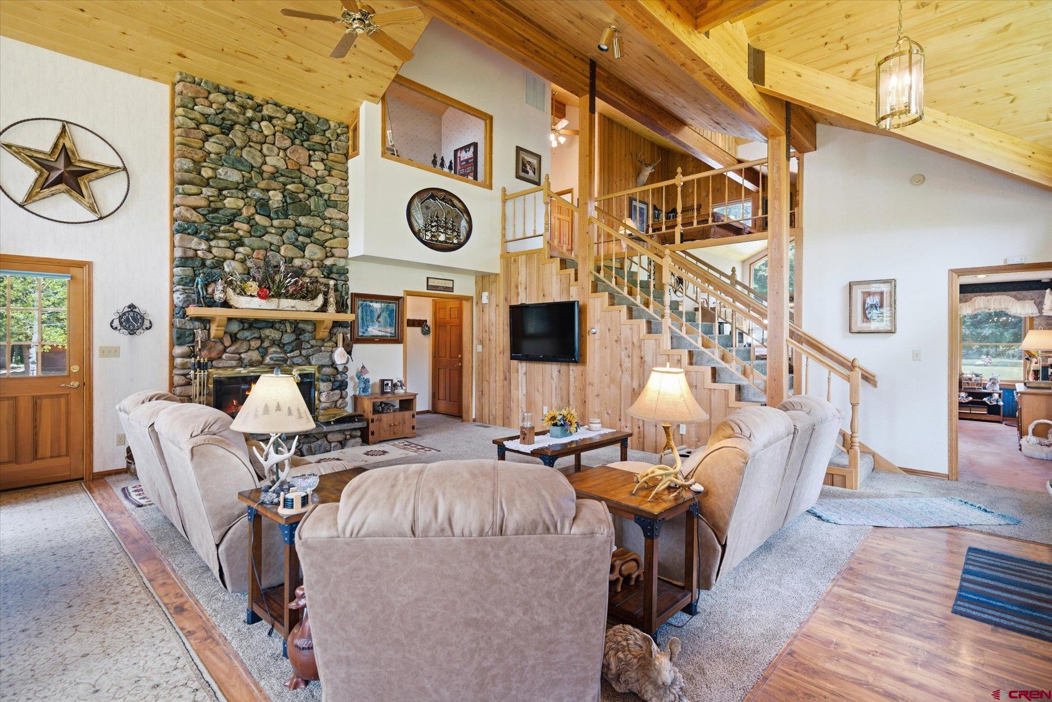 197 Hummingbird Way Bayfield, CO 81122 - Photo 9 of 44 a living room with couches a fireplace with wooden floor