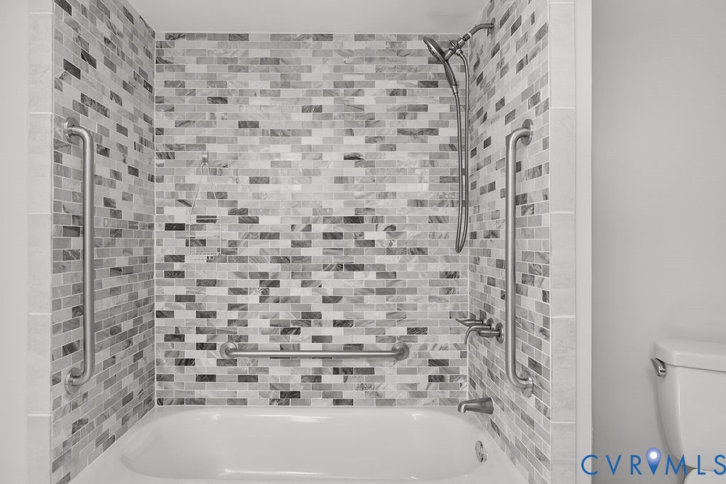 2956 Hathaway Road, Unit U704 Richmond, VA 23225 - Photo 28 of 42 Bathtub with a mosaic tile surround, featuring a w