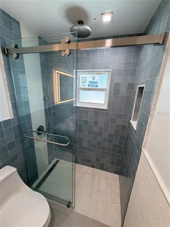 a bathroom with a toilet and a shower