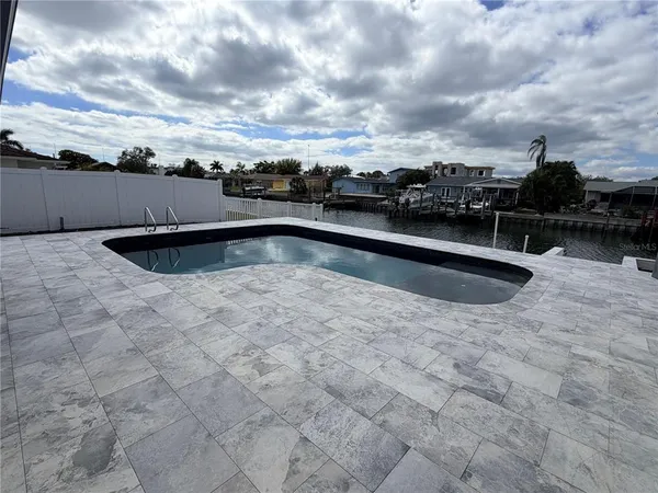 a view of swimming pool with a yard in the background