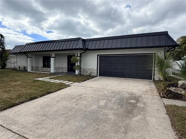 a view of a house with a yard and garage