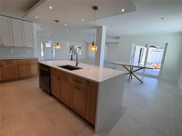 a kitchen with a sink cabinets and wooden floor