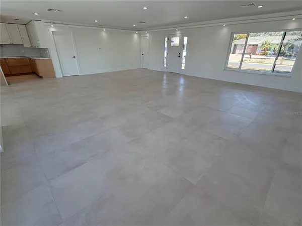 an empty room with a empty space and windows