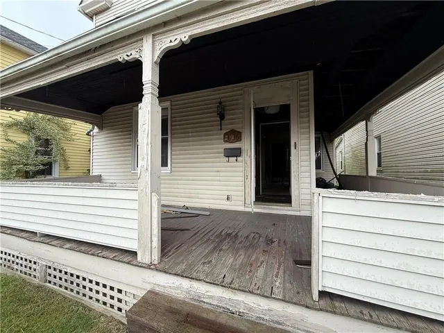 a view of a house with a door and wooden floor