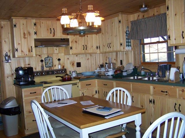 69 T 457 Corbin Road Hop Bottom, PA 18824 - Photo 6 of 12 a view of a dining room with furniture a kitchen and chandelier