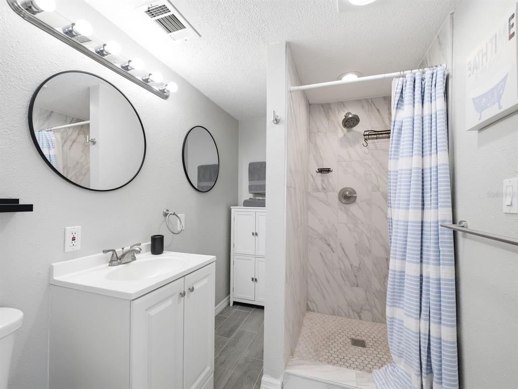1207 1st Street Indian Rocks Beach, FL 33785 - Photo 25 of 60 a bathroom with a sink and a mirror
