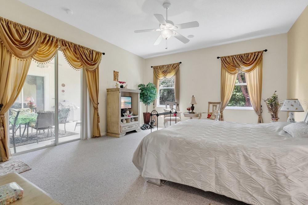 6139 Andreozzi Lane Windermere, FL 34786 - Photo 27 of 53 a bedroom with a bed and a chandelier