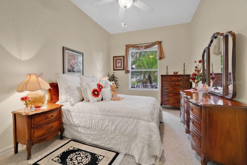 6139 Andreozzi Lane Windermere, FL 34786 - Photo 32 of 53 a bedroom with a bed and a chandelier