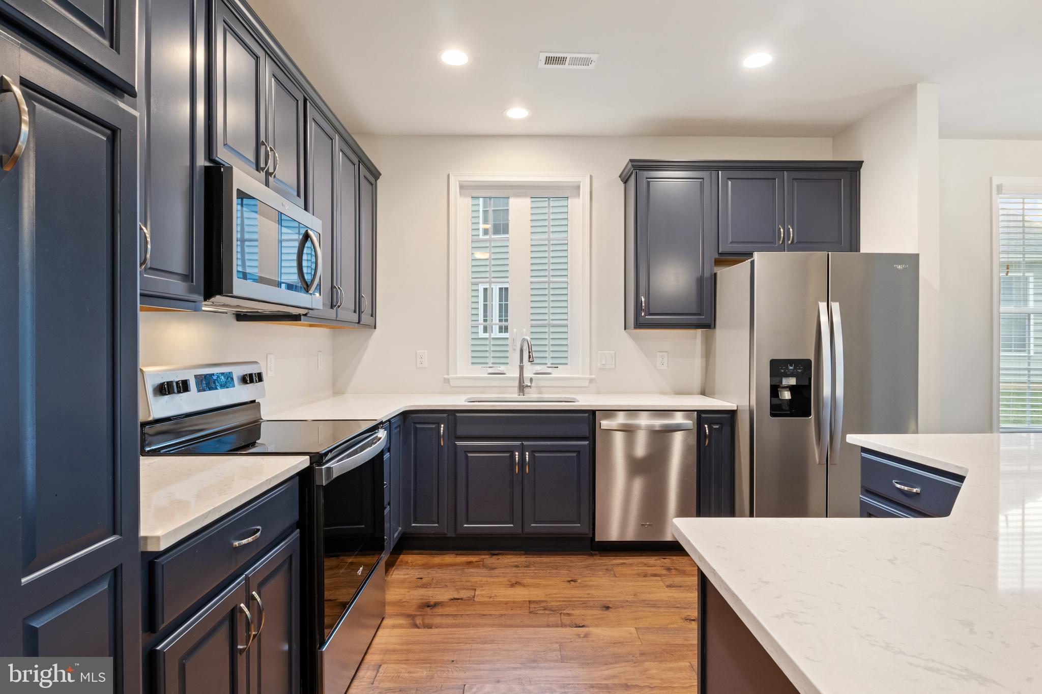 113 Garrison Drive Morganton, NC 28655 - Photo 7 of 63 a kitchen with stainless steel appliances granite countertop a refrigerator a sink dishwasher a stove top oven and a refrigerator