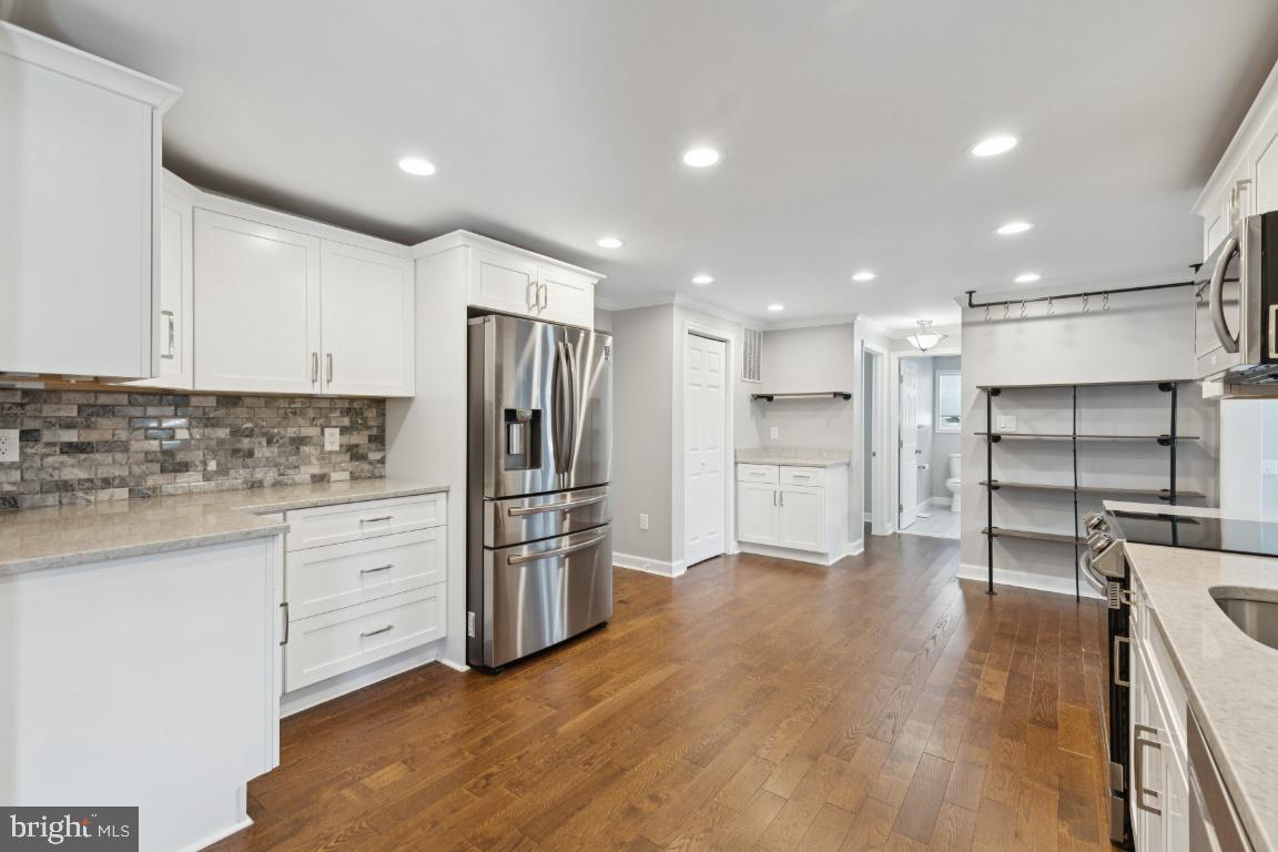 8368 Brock Bridge Road Laurel, MD 20724 - Photo 11 of 37 a kitchen with stainless steel appliances a refrigerator and a stove top oven